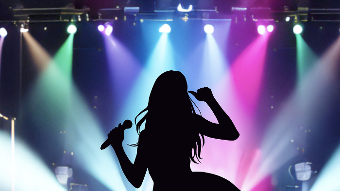 Female idol silhouette singing with microphone and spotlight_wide