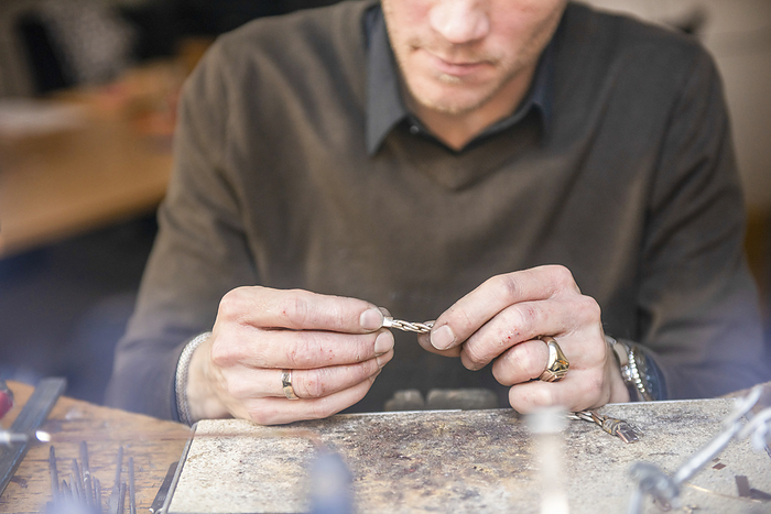 Goudsmid Watch maker repairing a classic watch, authentic work place. Using a monocle and small tiny tools for repairs
