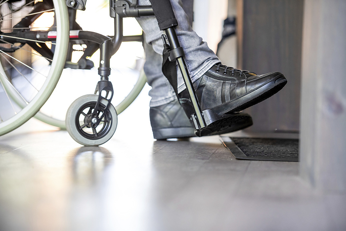 detail rolstoel Man in a wheelchair preparing to put his shoes on