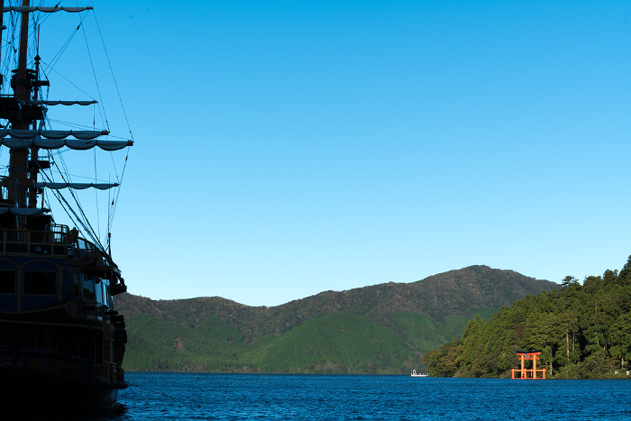 Scenery of Lake Ashinoko: Silhouette of a red torii gate and a pirate ship on the lake