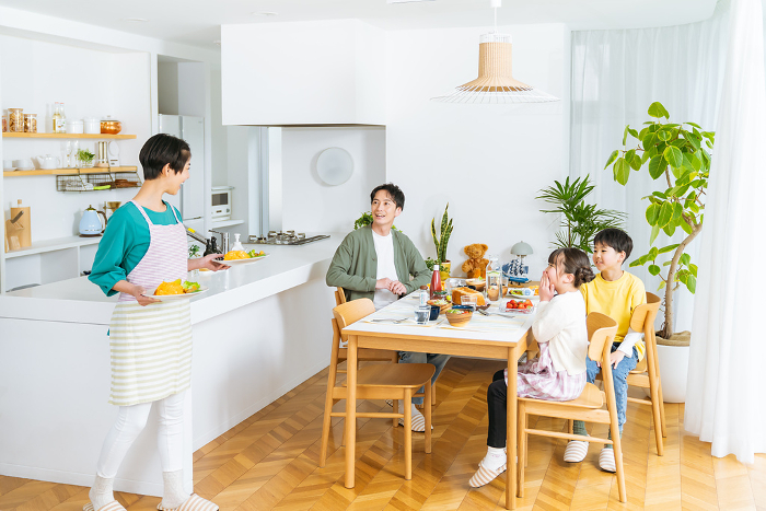 A Japanese family of four eating in the dining room (People)