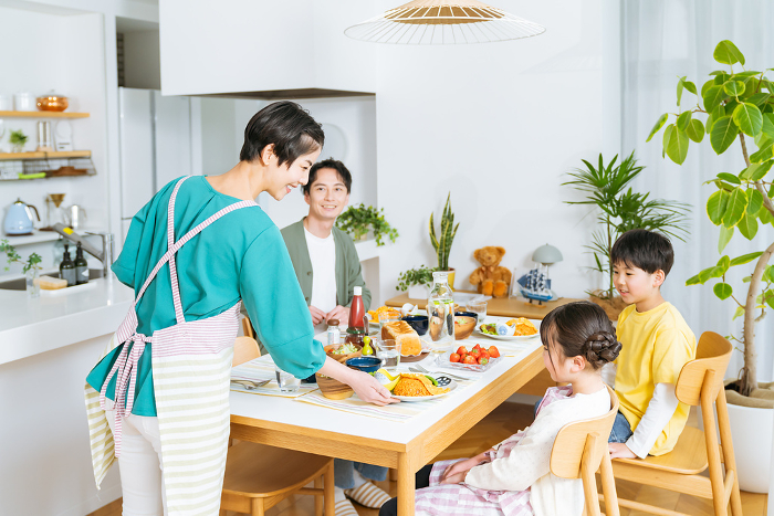 A Japanese family of four eating in the dining room (People)