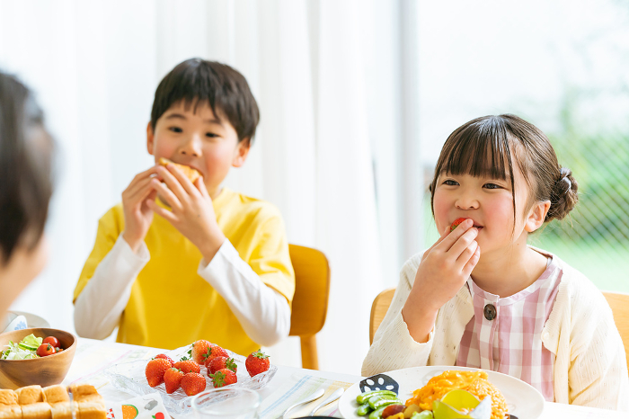 Japanese family eating in the dining room (People)