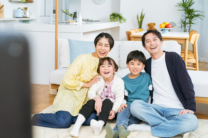 Japanese family of four watching TV.