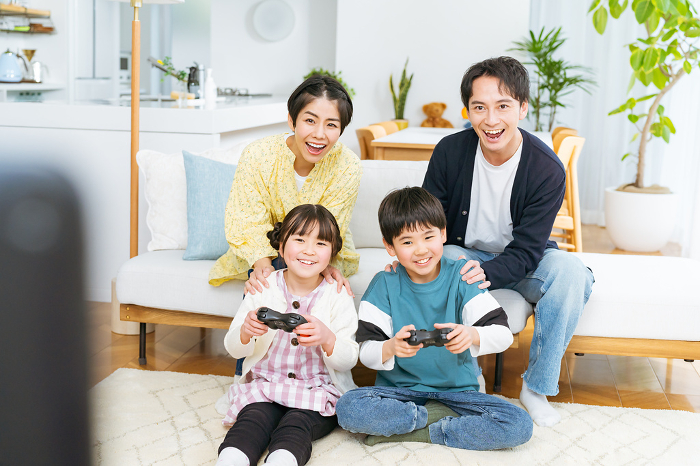 Japanese family playing a game in the living room (People)