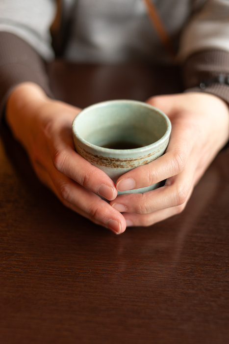 A person holding a teacup