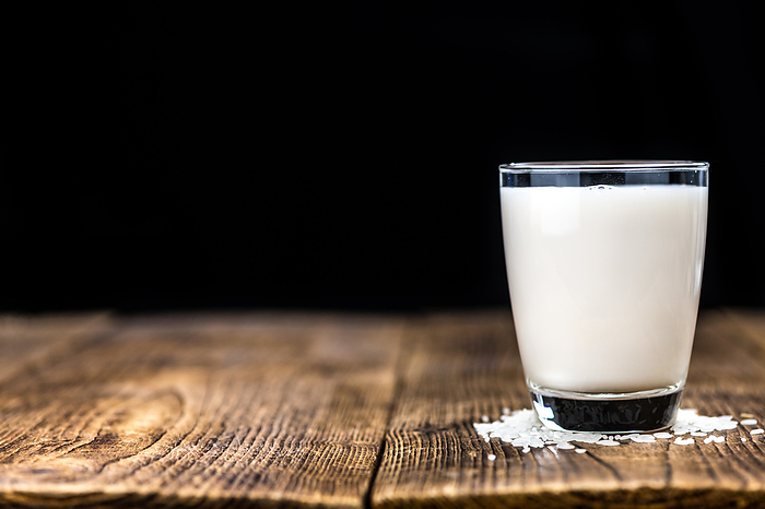 Portion of healthy Rice Milk on an old wooden table  selective focus  close up shot  Portion of healthy Rice Milk on an old wooden table  selective focus  close up shot , by Zoonar Christoph Sch