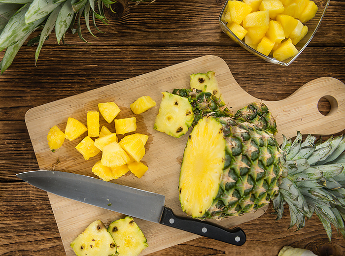 Portion of Pineapple  sliced  on wooden background, selective focus Portion of Pineapple  sliced  on wooden background, selective focus, by Zoonar Christoph Sch