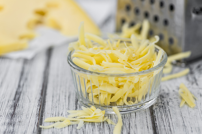 Wooden table with grated Cheese  close up shot  Wooden table with grated Cheese  close up shot , by Zoonar Christoph Sch