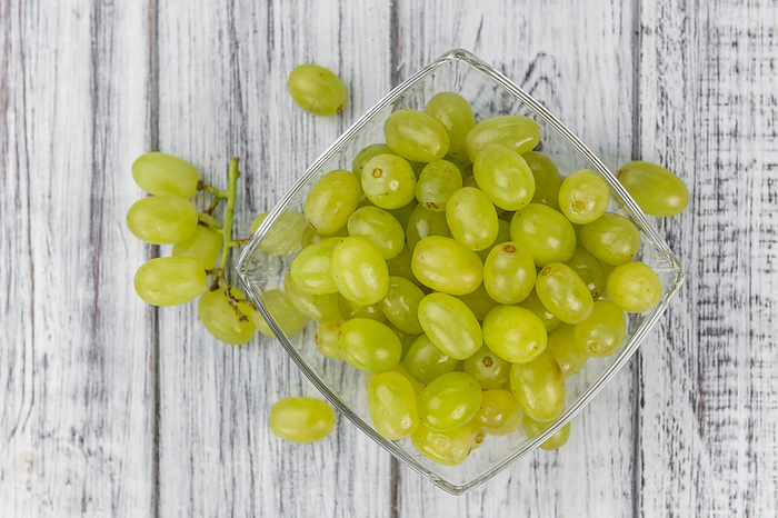 Some fresh White Grapes on wooden background  selective focus  close up shot  Some fresh White Grapes on wooden background  selective focus  close up shot , by Zoonar Christoph Sch