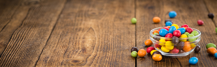 Portion of Cocolate coated Peanuts on wooden background  selective focus  Portion of Cocolate coated Peanuts on wooden background  selective focus , by Zoonar Christoph Sch