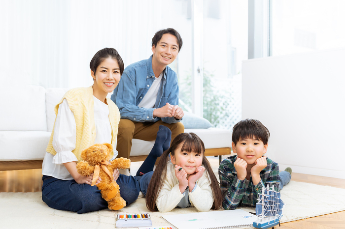 A Japanese family of four relaxing in the living room (People)
