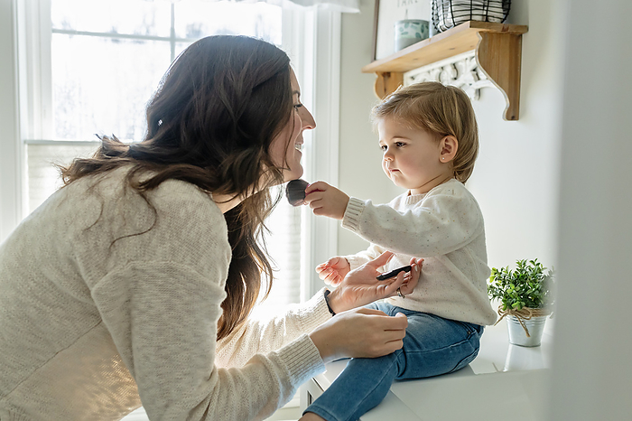 Toddler Girl Helping Mother Put on Make Up, by Cavan Images / Katie Pugliese Photography LLC