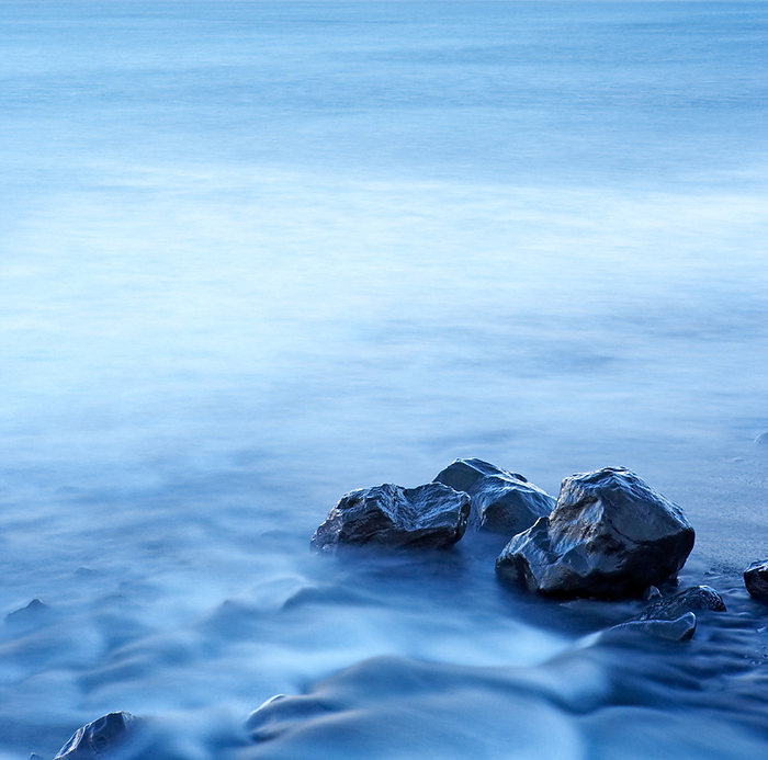 Blurred water around wet stone, by Cavan Images / dund photography