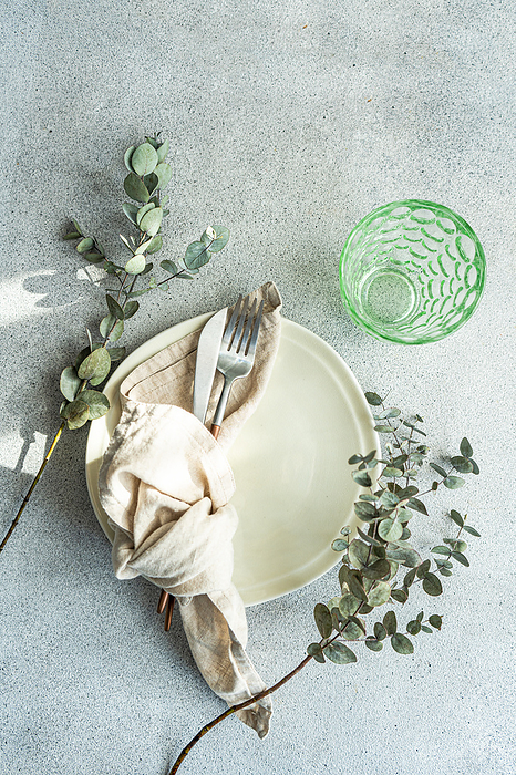 Rustic table setting with Eucalyptus leaves, by Cavan Images / Anna Bogush
