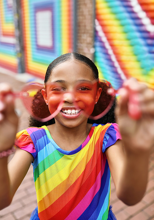 Girl smiling through heart Glasses in Washington, DC, by Cavan Images / Nikia Paden