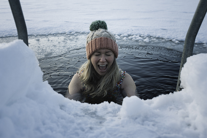 woman screaming whilst ice water cold water swimming in Scandinavia, by Cavan Images / Rachel Bell