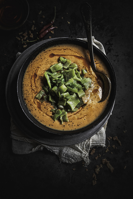 Bowl of Red Lentil Soup with Greens, by Cavan Images / Sara Ghedina
