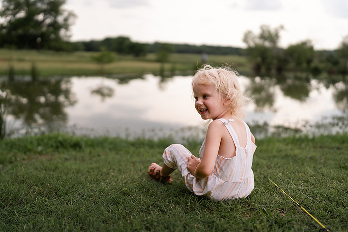 Little Girl Smiles While Enjoying Time Fishing At Family Pond, by Cavan Images / Cristin Franks Photography