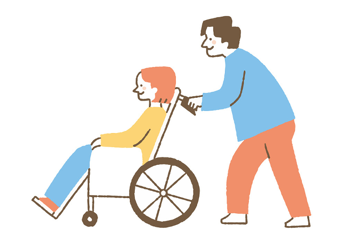 Man pushing a wheelchair with a young woman riding in it_Color