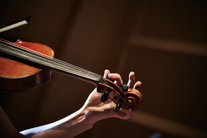 Close-up of hands playing the violin
