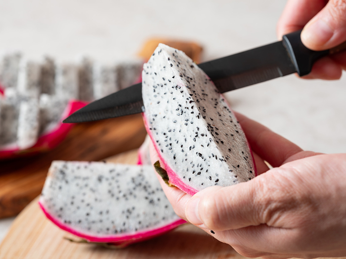 Cutting dragon fruit with a knife