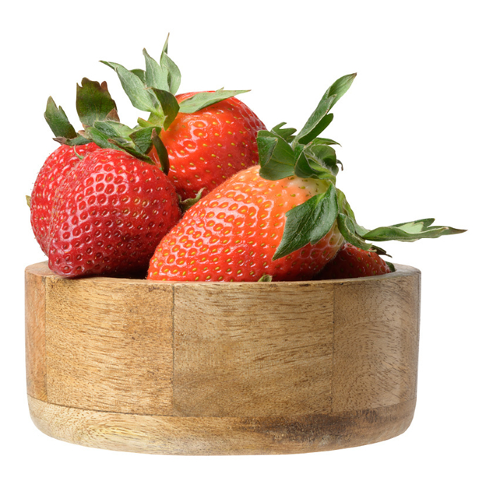 Ripe red strawberries in a wooden bowl on an isolated background Ripe red strawberries in a wooden bowl on an isolated background