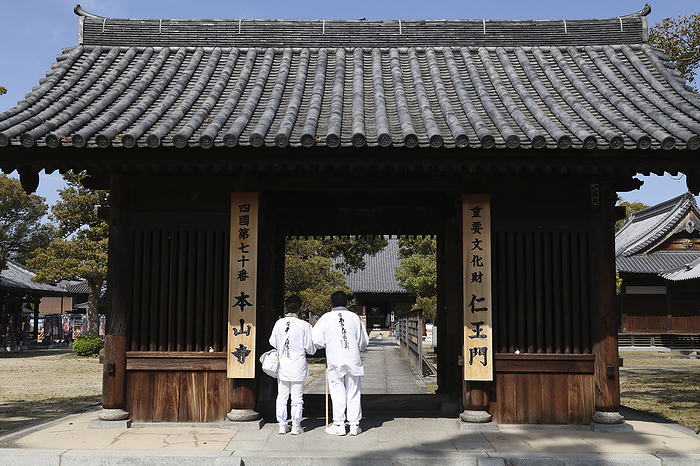 Niomon Gate and pilgrims at No. 70 Honzan ji Temple 88 sacred places in Shikoku