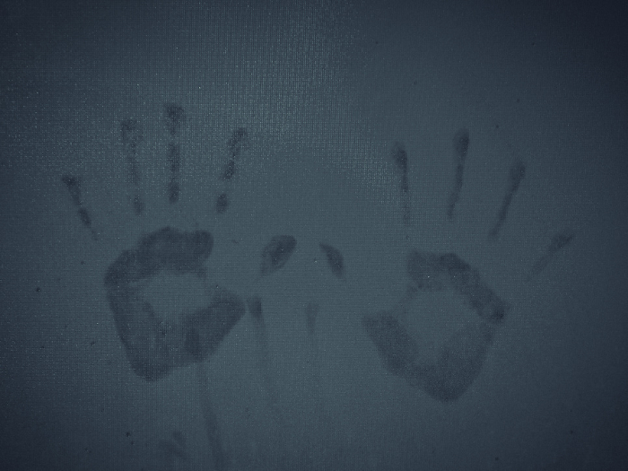 Child's handprint on windowpane