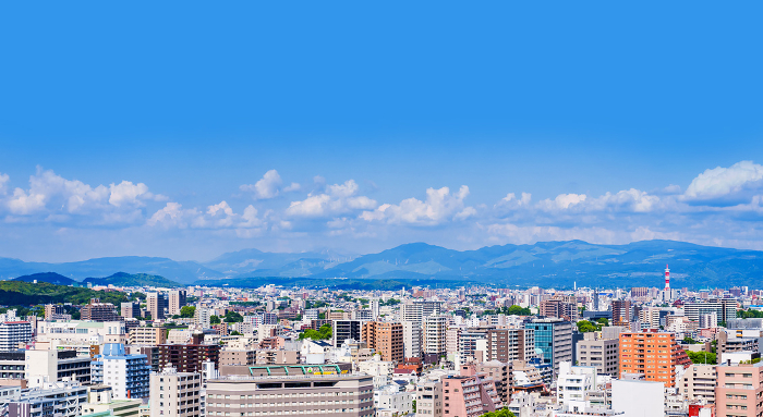 Panoramic view of Kumamoto city, Kyushu, Japan, with Mount Aso in the distance.