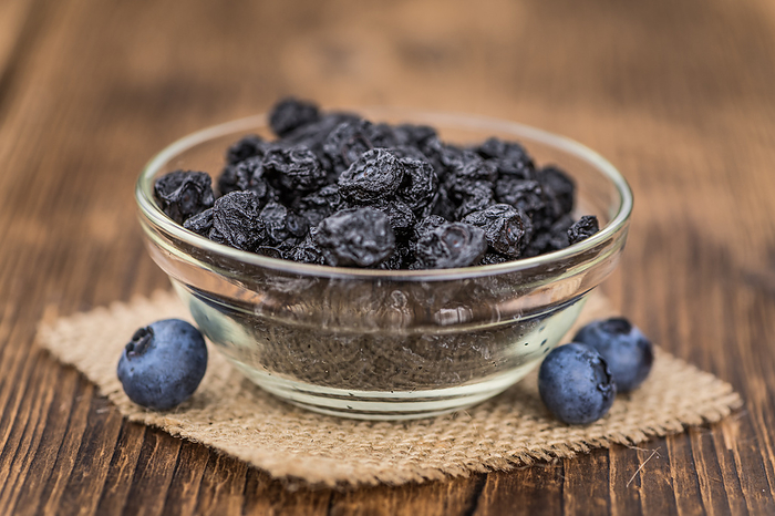 Dried Blueberries on wooden background  selective focus Dried Blueberries on wooden background  selective focus, by Zoonar Christoph Sch