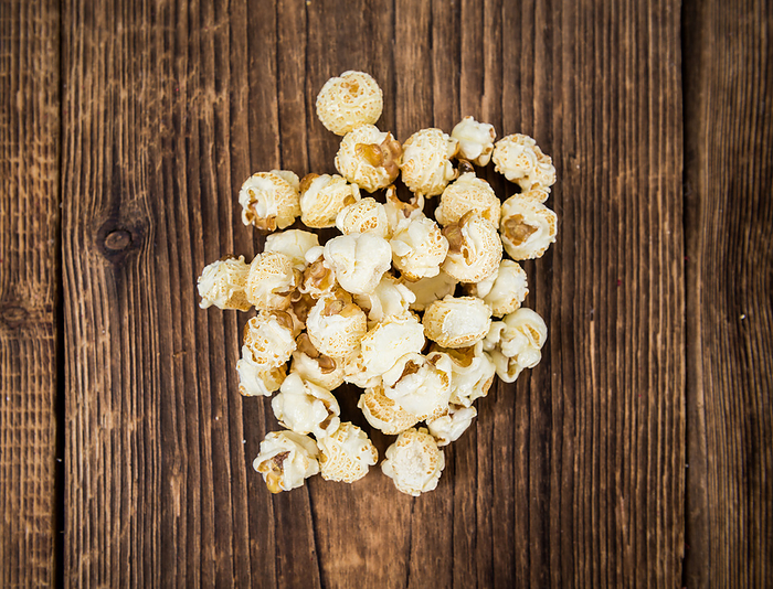 Portion of Popcorn on wooden background, selective focus Portion of Popcorn on wooden background, selective focus, by Zoonar Christoph Sch