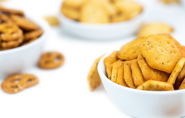 Portion of mixed Snacks isolated on white  close up shot  selective focus  Portion of mixed Snacks isolated on white  close up shot  selective focus , by Zoonar Christoph Sch