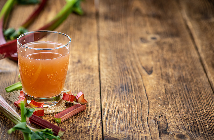 Old wooden table with fresh made Rhubarb Juice  close up  selective focus  Old wooden table with fresh made Rhubarb Juice  close up  selective focus , by Zoonar Christoph Sch