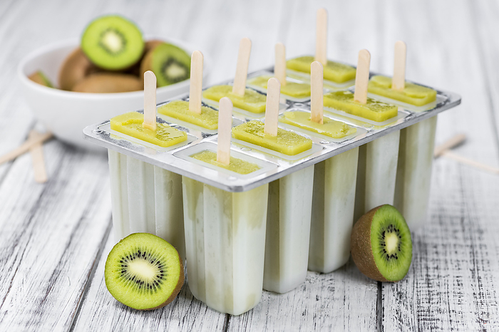 Some fresh Kiwi Popsicles on wooden background  selective focus  close up shot  Some fresh Kiwi Popsicles on wooden background  selective focus  close up shot , by Zoonar Christoph Sch