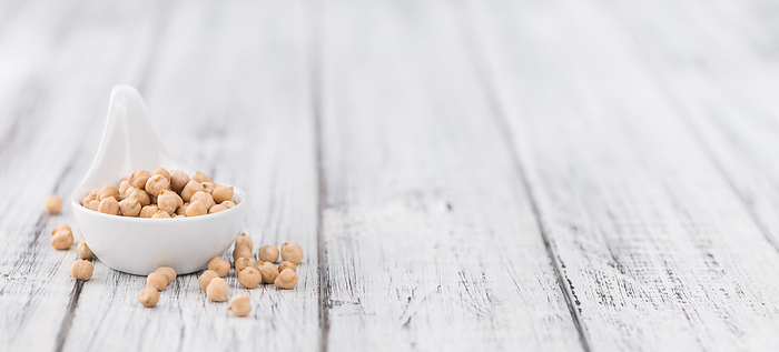 Dried Chickpeas on wooden background  selective focus Dried Chickpeas on wooden background  selective focus, by Zoonar Christoph Sch