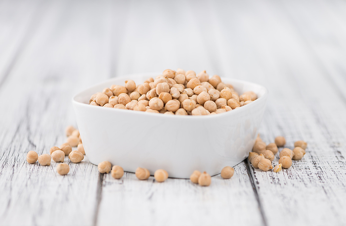 Dried Chickpeas on wooden background  selective focus Dried Chickpeas on wooden background  selective focus, by Zoonar Christoph Sch