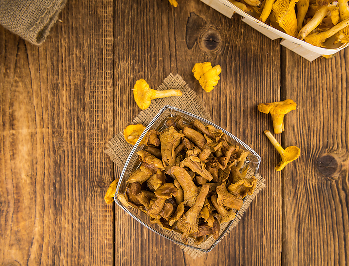 Wooden table with Canned chanterelles, selective focus Wooden table with Canned chanterelles, selective focus, by Zoonar Christoph Sch