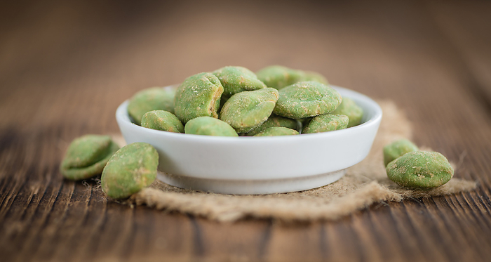 Portion of Wasabi coated Peanuts on wooden background  selective focus  Portion of Wasabi coated Peanuts on wooden background  selective focus , by Zoonar Christoph Sch
