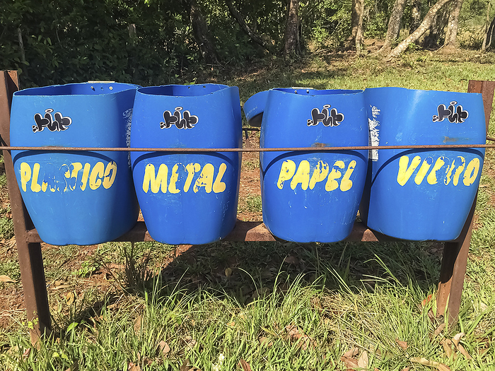 Close up of 4 blue waste separation boxes with yellow letters in a nature park, Lagoa das Araras, Bo Close up of 4 blue waste separation boxes with yellow letters in a nature park, Lagoa das Araras, Bo, by Zoonar Uwe Bergwitz