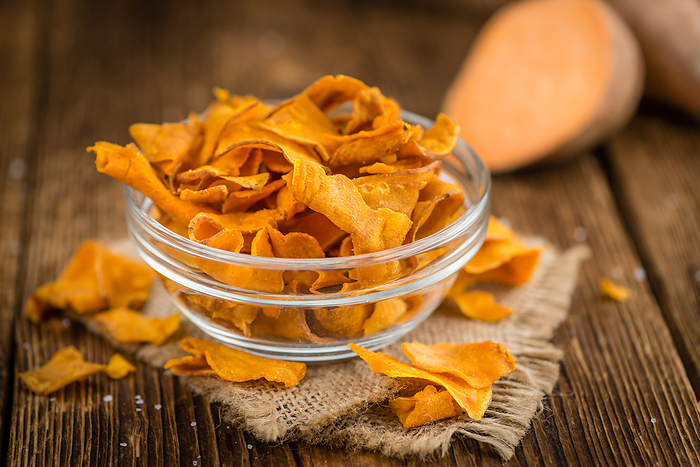 Fresh made Sweet Potato Chips on a rustic background Fresh made Sweet Potato Chips on a rustic background, by Zoonar Christoph Sch
