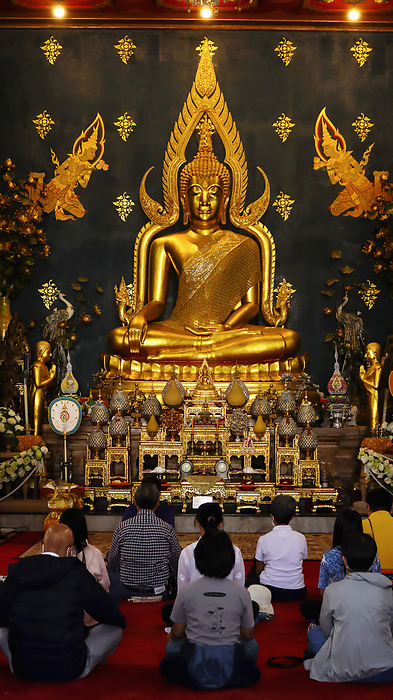 INDIA, BIHAR, BODH GAYA, January 2023, Devotee praying in front of Lord Budhha statue, Thai Monastery INDIA, BIHAR, BODH GAYA, January 2023, Devotee praying in front of Lord Budhha statue, Thai Monastery, by Zoonar RealityImages
