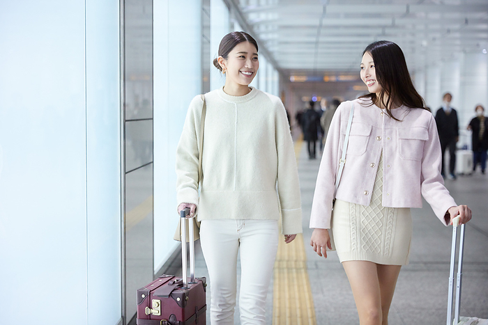 Two Japanese women talking while walking