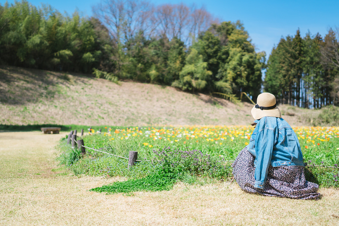 Woman enjoying a field of poppies