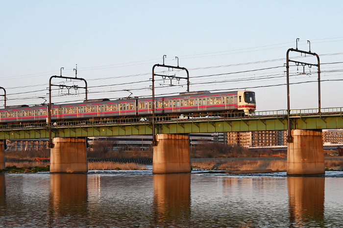 Keio train crossing a railroad bridge