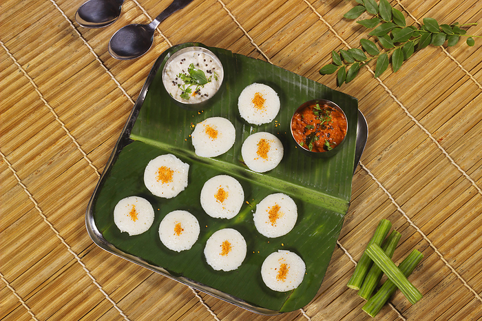Plain rava idli with chutney served on banana leaf Plain rava idli with chutney served on banana leaf, by Zoonar RealityImages