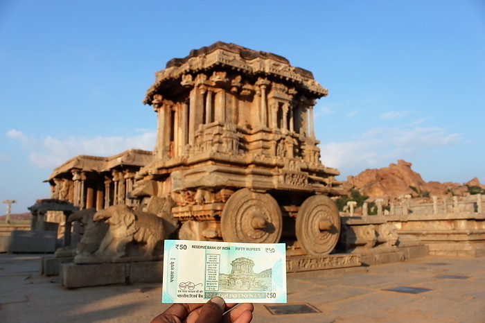 Stone chariot back drop with fifty rupees note, Vittala Temple, Hampi, Karnataka, India. Stone chariot back drop with fifty rupees note, Vittala Temple, Hampi, Karnataka, India., by Zoonar RealityImages