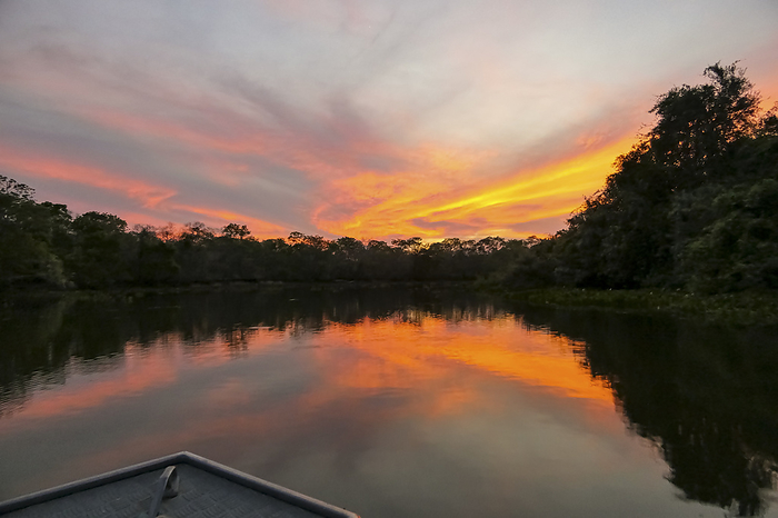 View from boat of wonderful sunset at a Pantanal river with reflections on water, Pantanal Wetlands, View from boat of wonderful sunset at a Pantanal river with reflections on water, Pantanal Wetlands,, by Zoonar Uwe Bergwitz