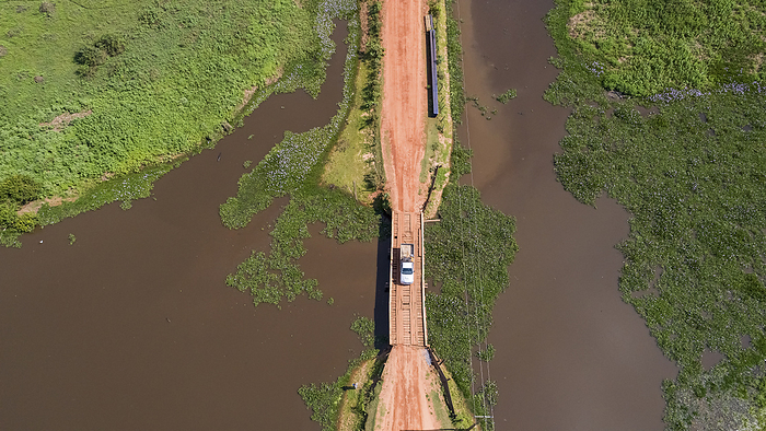 Close up aerial view of a Pick up truck crossing a bridge over a lagoon, Transpantaneira, North Pant Close up aerial view of a Pick up truck crossing a bridge over a lagoon, Transpantaneira, North Pant, by Zoonar Uwe Bergwitz