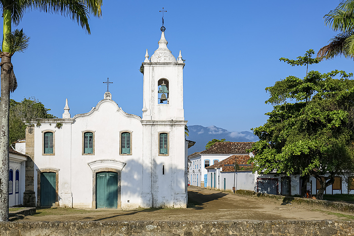 Church Nossa Senhora das Dores  Our Lady of Sorrows  with two palm trees on a sunny day, historic town Paraty, Brazil Church Nossa Senhora das Dores  Our Lady of Sorrows  with two palm trees on a sunny day, historic town Paraty, Brazil, by Zoonar Uwe Bergwitz